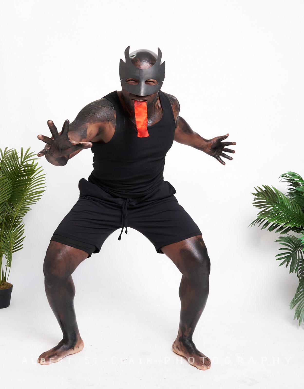 Jab Jab portrait — male performer in oil and mask